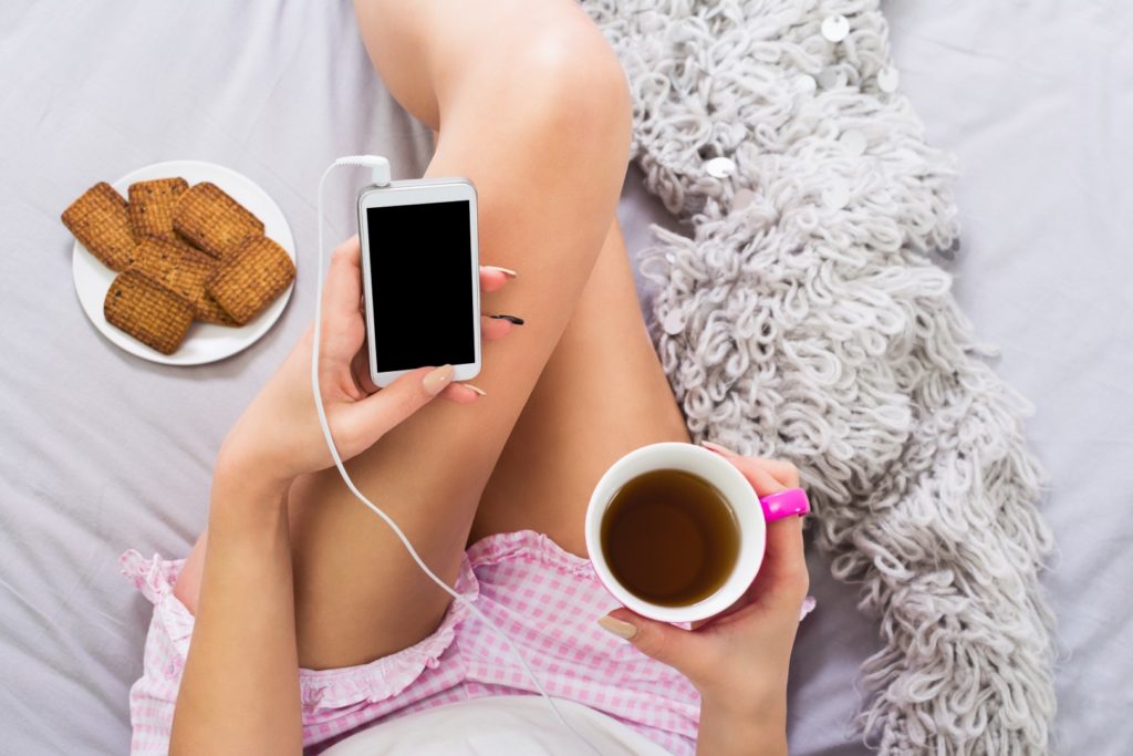 Drinking a hot drink in bed to relax