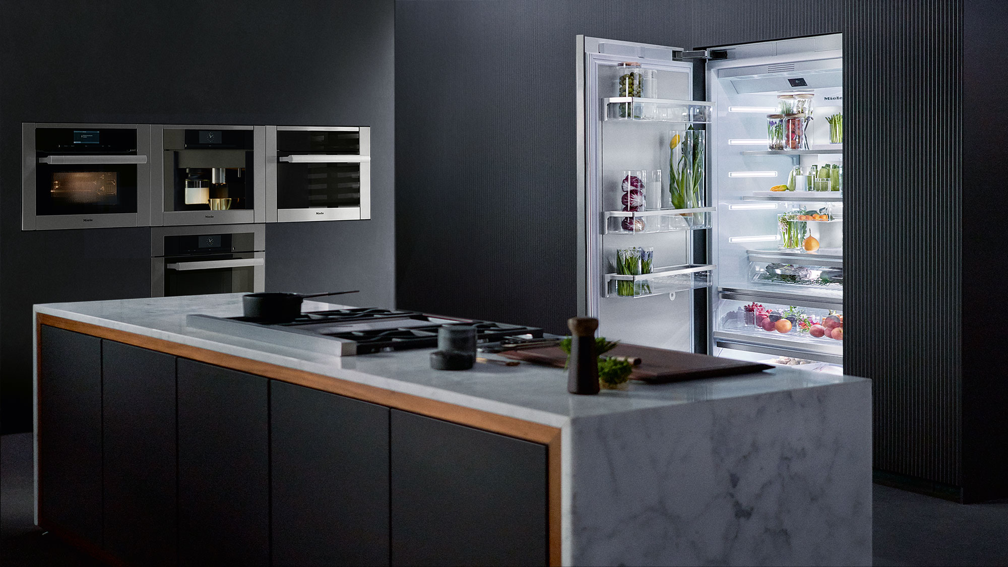 black contemporary kitchen outfitted with Miele appliances