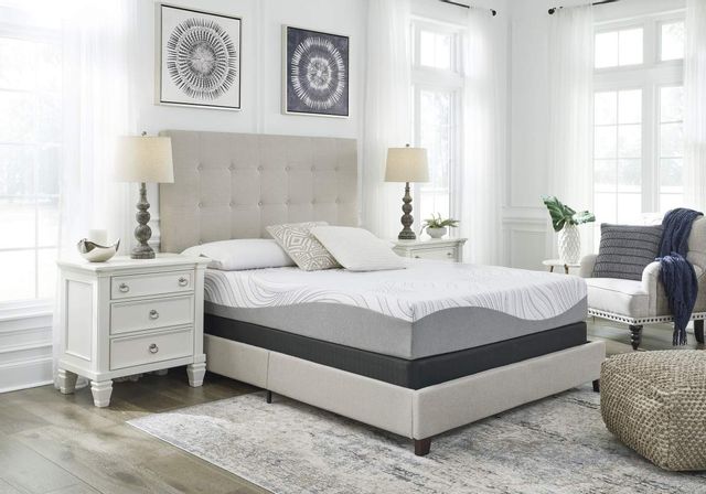 front view of a modern white bedroom with a mattress from a box on a grey bed frame