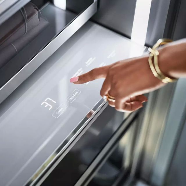 closeup view of a hand setting the temperature in a dacor refrigerator