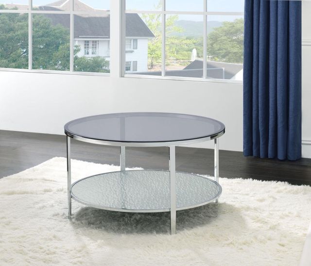 round cocktail table with glass top and lower shelf and metallic silver trim and legs