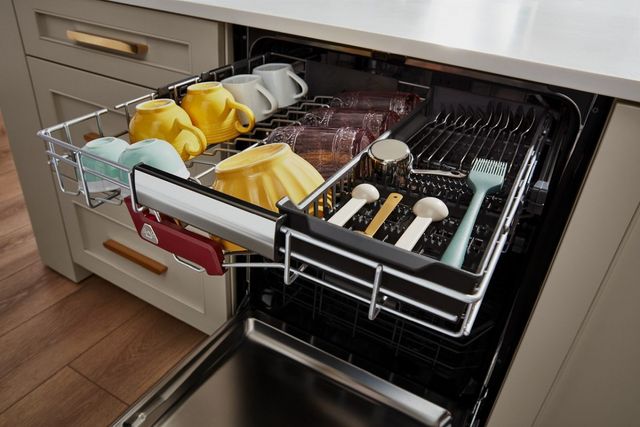 close view of the top rack of a kitchenaid dishwasher pulled out with glassware in it