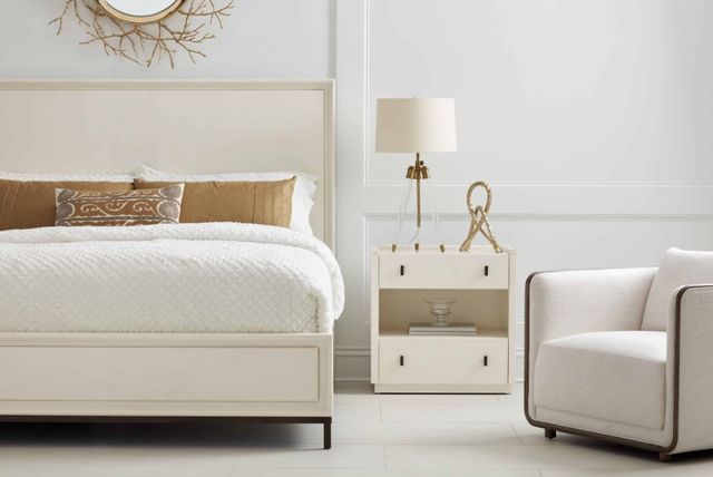 front view of a white nightstand and bed in a modern white bedroom