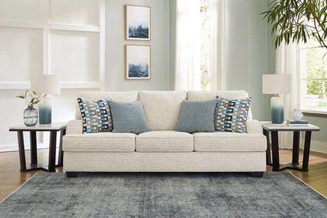 front view of a transitional style cream sofa in a modern living room with light blue accents