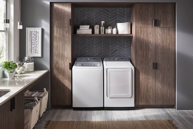 front view of a modern grey laundry room with a white samsung washer and dryer