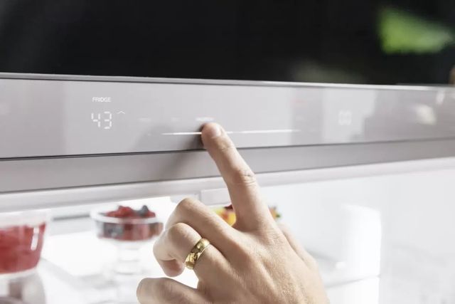 close view of a person setting the temperature inside their refrigerator