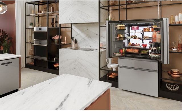 front view of a modern kitchen with black open shelving and a white french door refrigerator