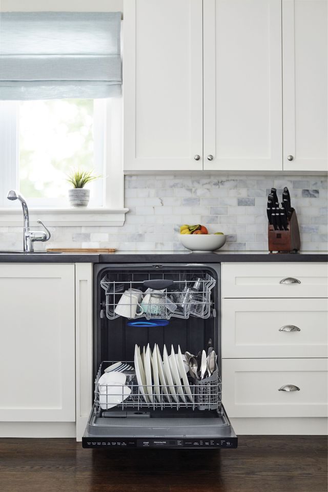 Frigidaire dishwasher with dishes in and door ajar