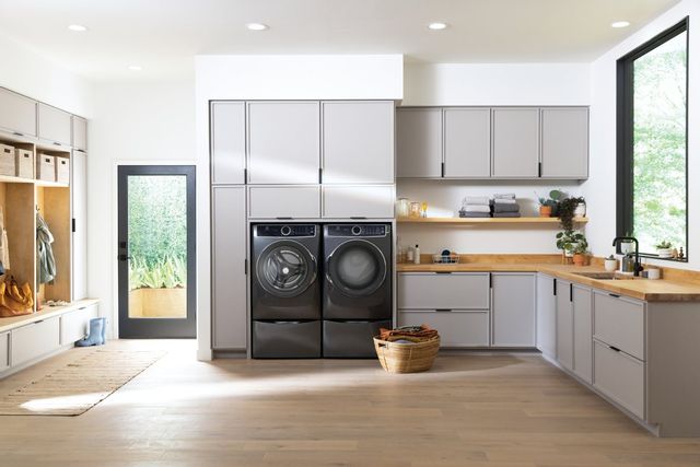 white laundry room with black electrolux washer and dryer