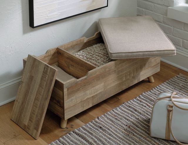 view of a bedroom storage bench, opened to show the two storage compartments