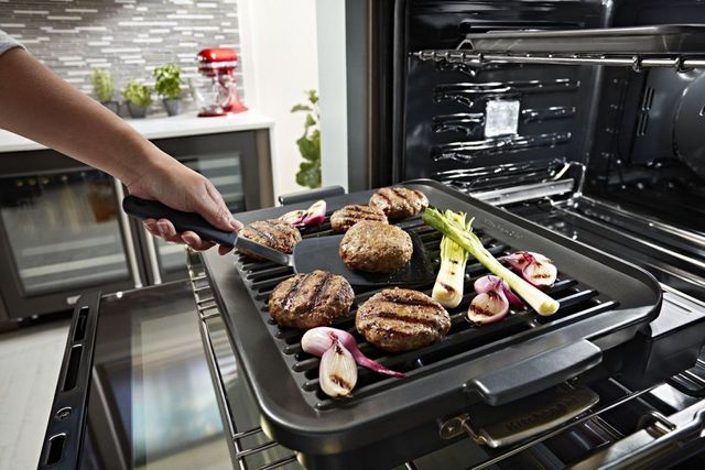 Someone rotates food as it is cooked in a KitchenAid oven
