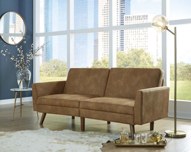 a modern couch in a living room with blue walls