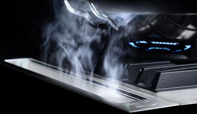 ductless range hood expelling smoke from a cooktop