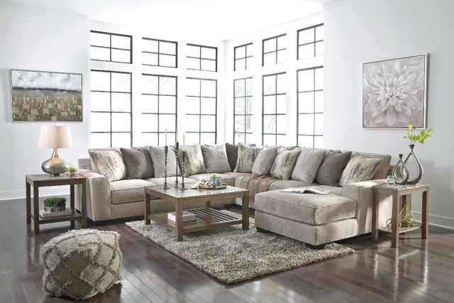 front view of a large living room with a beige u-shaped sectional and matching decor