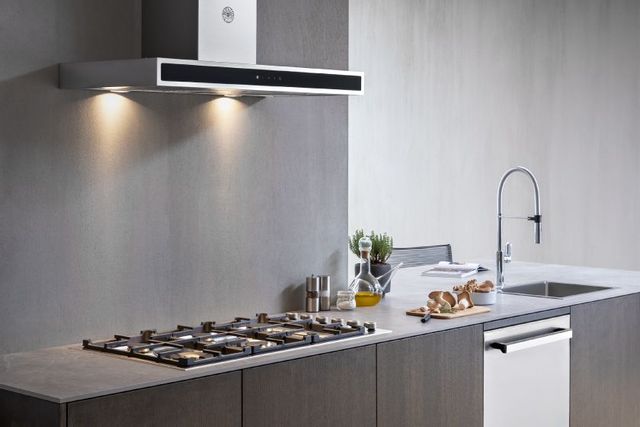 front view of a gas cooktop in a grey kitchen 