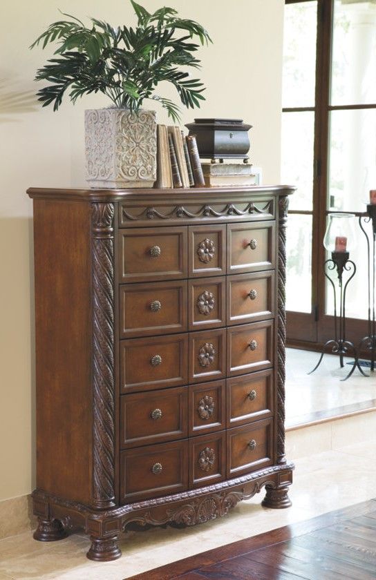 front view of an ornate brown wood bachelors chest of drawers