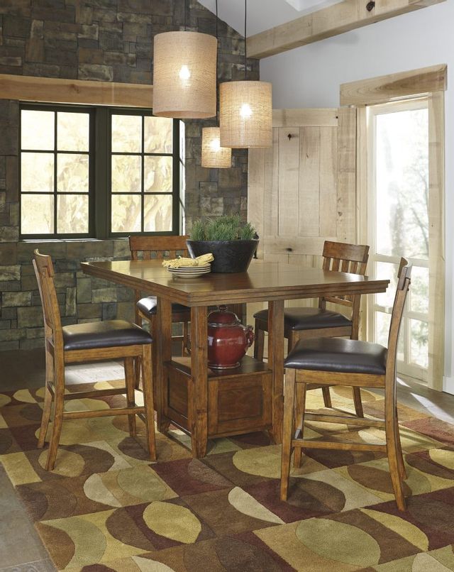 a wood dining room table with wood and leather seats