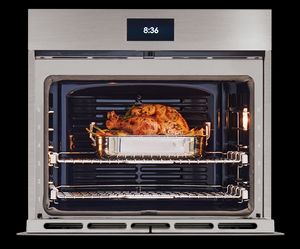 The inside of a Wolf electric oven is shown as it cooks a turkey