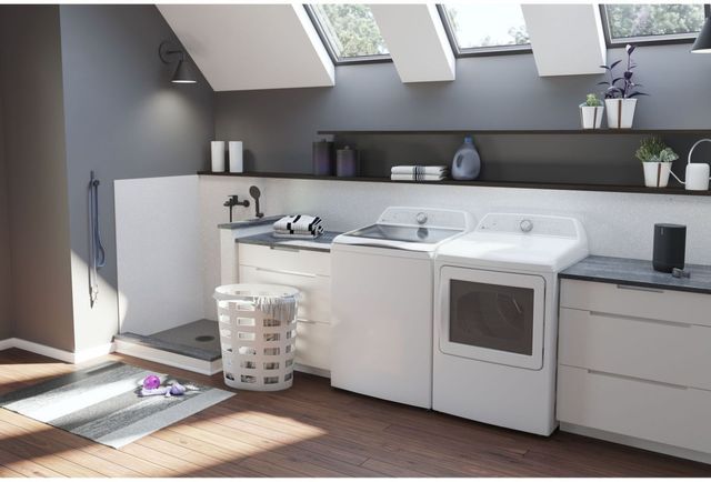 front view of a modern laundry room with grey walls and a white GE Profile top load washer and dryer