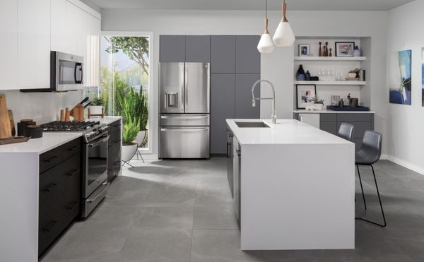 Stylish kitchen featuring a stainless steel GE Profile 4-french-door refrigerator