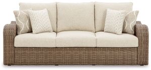 front view of the Signature Design by Ashley® Sandy Bloom Beige Outdoor Sofa with Cushion,a brown resin wicker outdoor sofa with beige cushions