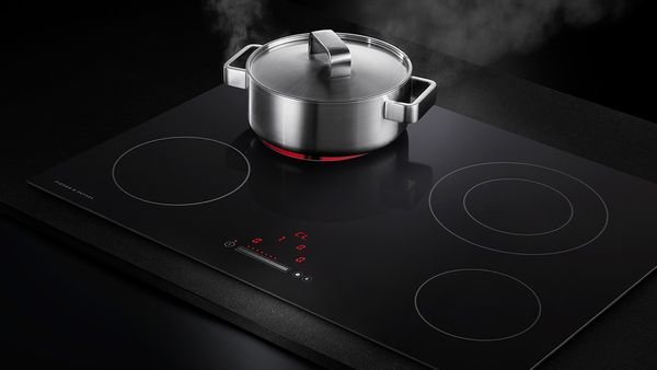 A pot boils on top of a 30" electric cooktop