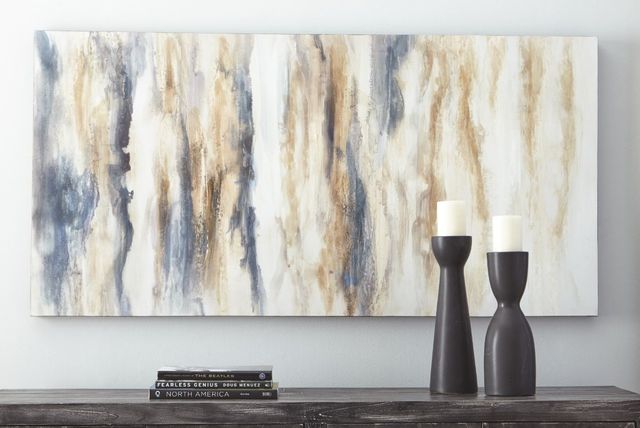 front view of a blue and tan wall art piece above a mantle with books and candles on it