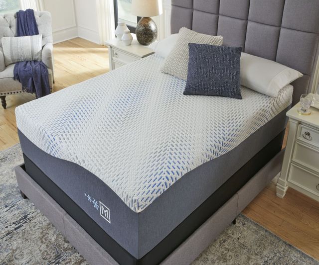 gel memory foam mattress on a grey upholstered bed frame in a modern bedroom