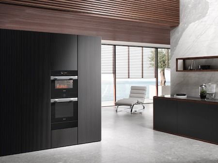 Kitchen Featuring a Miele 24" Clean Touch Steel Ovens