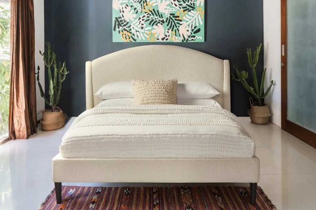 front view of a white upholstered bed frame in a modern costal bedroom