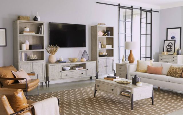 front view of a mid-century modern living room with modern light wood furniture, including an entertainment cents=er