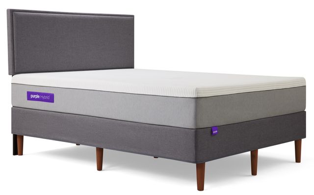 Purple hybrid mattress on an upholstered bed frame