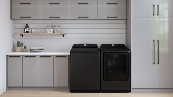 Laundry Room Featuring a Samsung 5.2 Cu. Ft. Brushed Black Top Load Washer