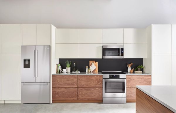 Kitchen Showcasing a Bosch 500 Series 21.6 Cu. Ft. Stainless Steel Counter Depth French Door Refrigerator