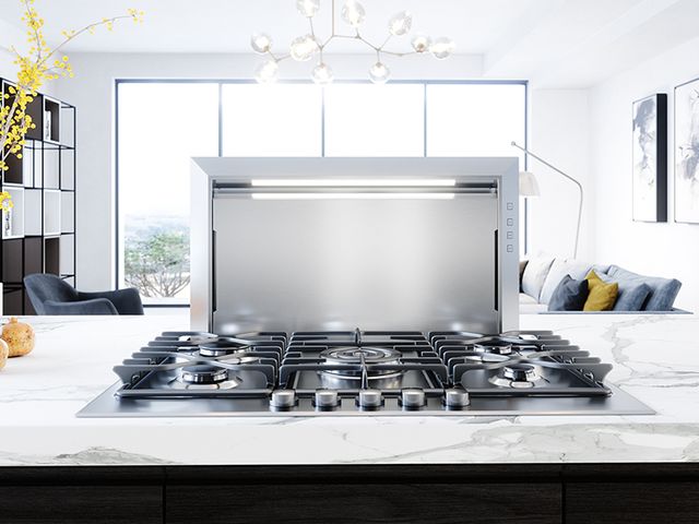 front view of a a downdraft range hood behind a gas cooktop