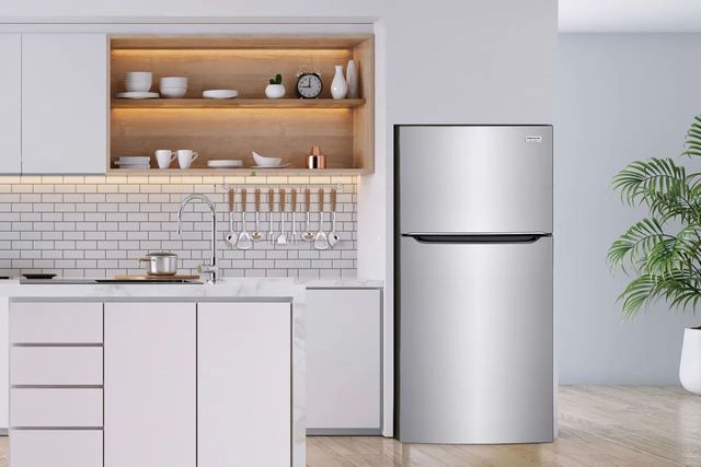 front view of a modern white kitchen with a stainless steel top freezer refrigerator