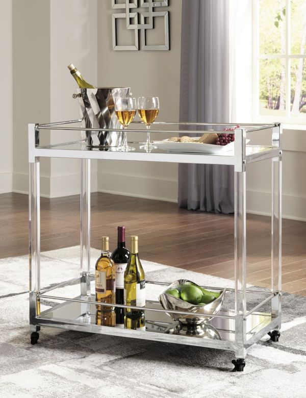 front view of a glass and metal bar cart with various glasses and drinks on it