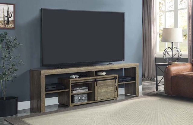 front view of a modern living room with blue walls and a distressed wood tv modern tv stand with a tv off on top