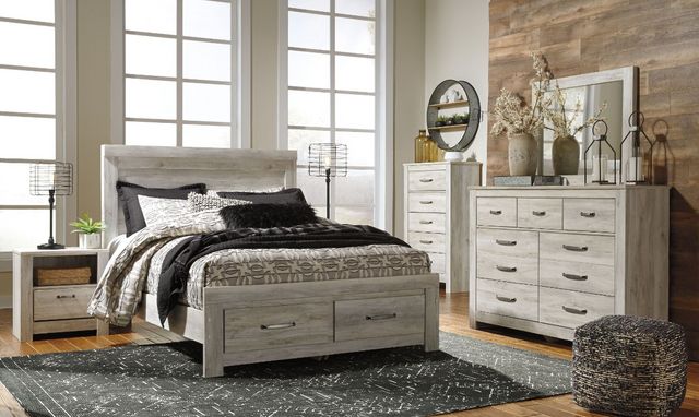 view of a farmhouse bedroom with a white wooden panel storage bed