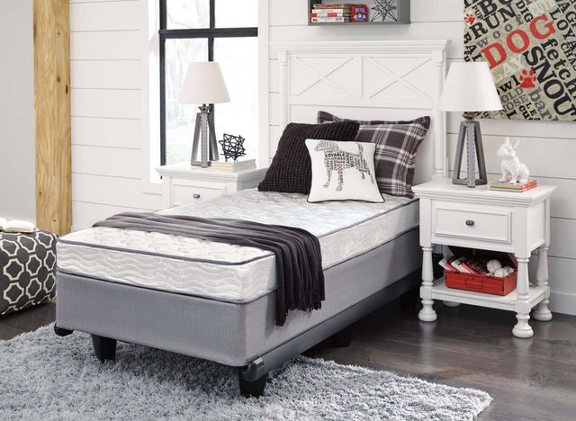 front view of a twin size mattress from a box on a bed in a dog-themed bedroom