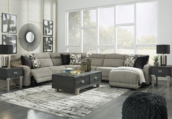 Modern living room featuring a gray Power Reclining Sectional and stylish coffee tables