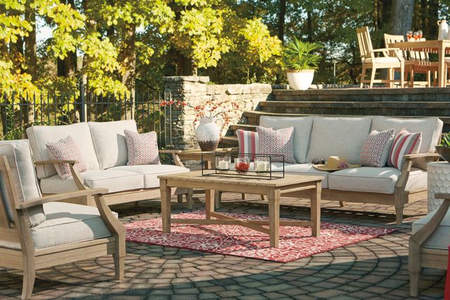 front view of wooden outdoor furniture in a backyard patio