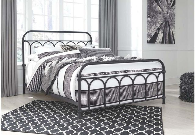 front left view of a black metal bed frame in a black and white modern bedroom