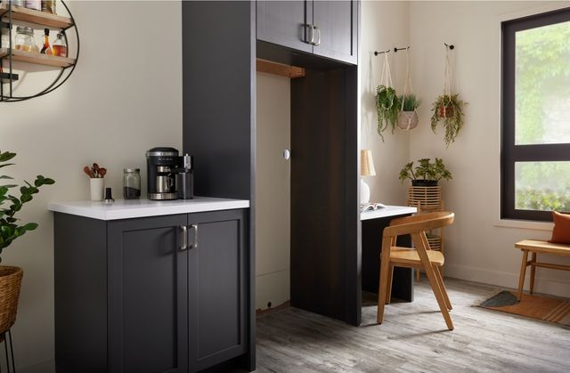 view of a modern kitchen with cabinets leaving space for a refrigerator