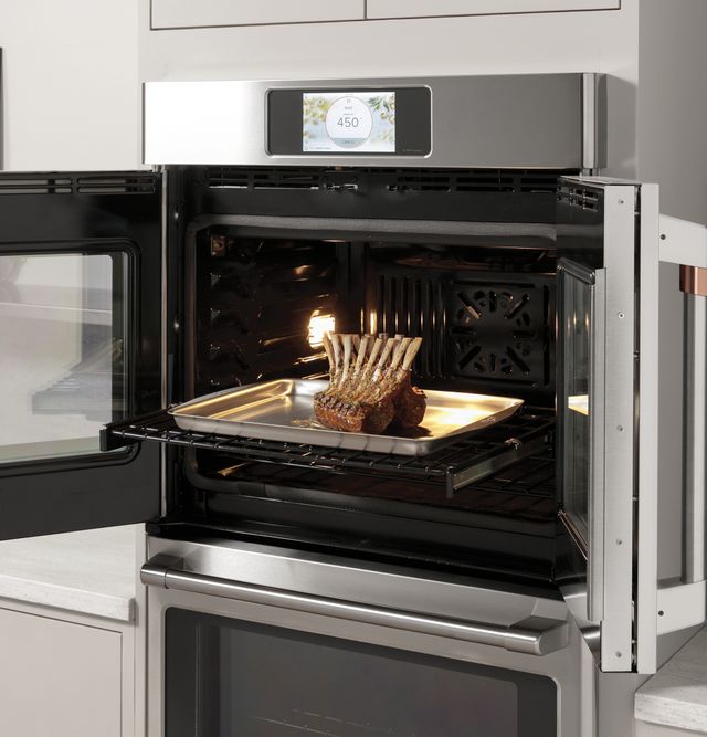 front angled view of a Monogram french door oven, opened, with a roast inside