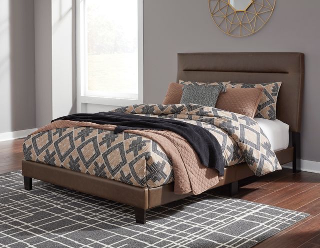 a bed in a bedroom with grey walls