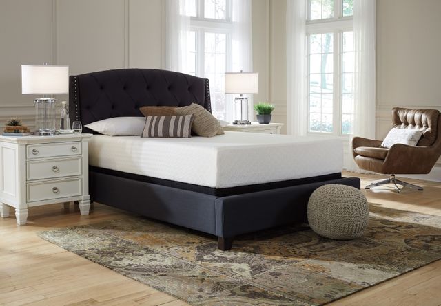 front view of a modern bedroom with white walls, grey accents, and a Sierra Sleep mattress from a box on the bed