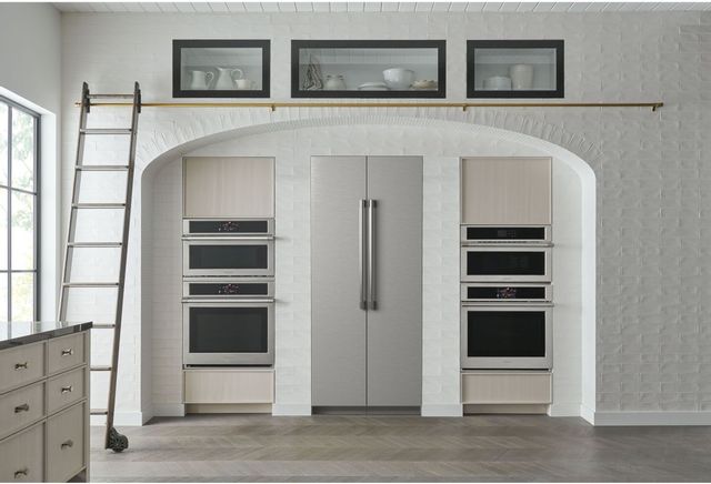 front view of two column refrigerators built into the wall between two double wall ovens