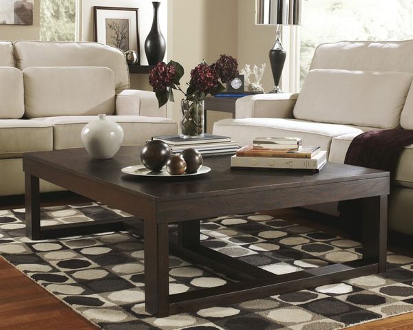 front view of a brown wood coffee table with accents atop