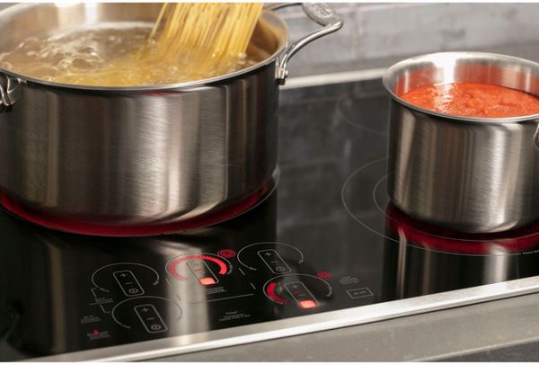 Kitchen featuring a GE Profile 30" Stainless Steel/Black Built-In Electric Cooktop